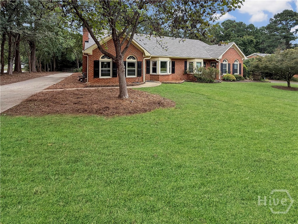 Welcome home to this brick Townhome with 2 bedrooms and 2 bathrooms plus a sunroom.  You will look forward to coming home to this oasis.  Walk in the front door to a large open floor plan with the Great Room with a fireplace and newer LVP flooring throughout the home.  The higher ceiling in the living room makes the space feel even bigger.  There is a wood stained beam that separates the Great Room from the Dining Room area.  It is open to the Dining Room and the Kitchen.  The Kitchen has tile counter tops, kitchen nook with storage and a microwave, pantry closet, and newer stainless steel oven, dishwasher and refrigerator.  The Sunroom is off the Kitchen that includes the washer and dryer connections.  The bedrooms are down a hall.  The large Master Bedroom is on the backside of the home with two closets and a full bathroom with a double vanity and a separate walk-in tile shower and water closet.  The front spacious bedroom has two large closets and a full bath that has been updated with a tub and tile surround.  Off the Sunroom is a back patio and two vehicle carport with a storage shed to store your lawn equipment and tools.  There is a great fenced area in the wooded backyard that is shaded.  The HOA and the community pool at Cedar Creek are voluntary.  It is convenient to stores and UGA.  The new roof was installed in September 2025, the appliances are a couple months old, new kitchen sink, new 200 AMP electrical box in April 2025, new Dining Room light, canned lights in Kitchen are new, brick around the hearth is new, interior repainted in 2025, drainage lines in the back of the home were replaced September 2025, and pallet of zoyzia sod in stalled in the front lawn.