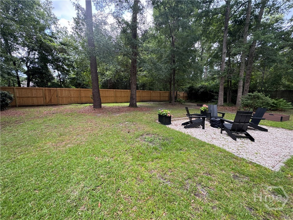 Large level lawn w/ gathering areas & privacy fenced