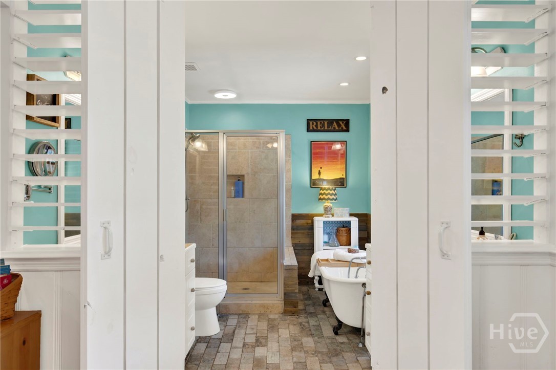 louvered entrance to primary bath offers privacy a