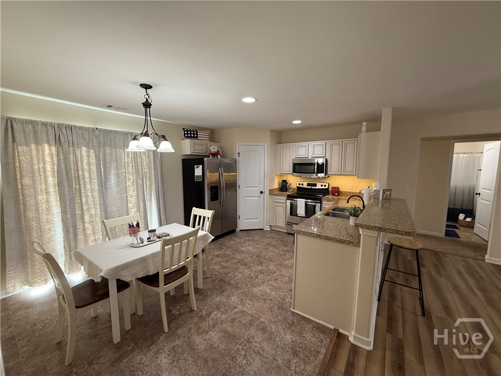 Kitchen with a large corner pantry, eat at bar top, open floor plan with sliding glass door opening to the grilling patio out back.