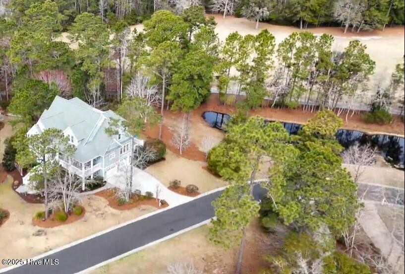 Southern Low-Country custom-built home sits in a quiet cul-de-sac on a .47-acre parcel that is privately bordered by adjacent pond.  Fortified Roof 2025, fresh paint, is better than ever.  Multi-level backyard balcony and decks, covered porch, and 3 season room overlook the colorful views of the property's landscaping and Fred Couples signature golf course Heron 6.  Looking for a home that fits an active lifestyle?  Looking for an amenity rich community but desire a property with a little bit more acreage and privacy?  Perhaps one with a spacious 30 x 35 ft. garage large enough for a Hobbyists' tools, Trucks and toys?  Are you a creative thinker or skillful craftsman looking for a 15 x 14 ft. heated workshop? You found 1772 Candle Ridge.  Whatever your creative talents may be, the ground floor provides over 500 sq ft of additional unconditioned spaces for crafting, fitness, or extra storage.  This well-maintained custom home built by Cameron Smith was designed for entertaining and an active lifestyle.  Take the elevator to the heart of this home's main living area.  The two-story Great Room has a wet bar adjacent to dining area and Kitchen.  Hardwood flooring seamlessly unites this open floor plan while surround-sound music follows you throughout. Built-in carpentry frames the fireplace.  The home chef's kitchen has granite countertops, center-island gas cooktop with abundant prepping areas and hardwood cabinetry.  Retreat to the west wing primary bedroom ensuite, tiled glass enclosed shower, walk-in closets, and laundry room.  Home office off the two-story foyer entrance.  The upstairs loft leads to three guest bedrooms and fully tiled bathroom.  The Rinnai tankless water-heater provides long showers or pampered soaks in the whirlpool tub.  HVAC system replaced in 2022.  This home sits high with multiple backyard decks and a wrap-a-round front porch which provides private places to enjoy nature. LOCATION - LOCATION - LOCATION:Award Winning Winding River is 40 minutes South of Wilmington, one-hour north of Myrtle Beach Airports, and minutes from the Historic Seaport town of Southport. If you like the Coastal Lifestyle, you will love that Winding River has its own Ocean Front Beach Club w/ Pool, on quiet Holden Beach. Boaters have 2 Marinas, one on the Intracoastal Waterway and the second at our "River House" Clubhouse on the Lockwood Folly River. You can go to your Beach Club by Boat! Come and see why the amenities at Winding River are "The best kept secret". Enjoy gatherings at the Property Owners Club House and Event Center, or at the Poolside Pavilion B.Y.O.B. Bar, Picnic and Grilling Areas. There are a variety of activities and plenty of fun-loving people to share good times with. Sometimes it is "all about fun and games" including the Carolina National, Fred Couples 27-hole Audubon Golf course, Fitness Center, Walking Trails, Tennis, Pickle, or Bocci Ball? Come Plant Some Roots in our Community Garden and Start Owning Your Dreams Now!