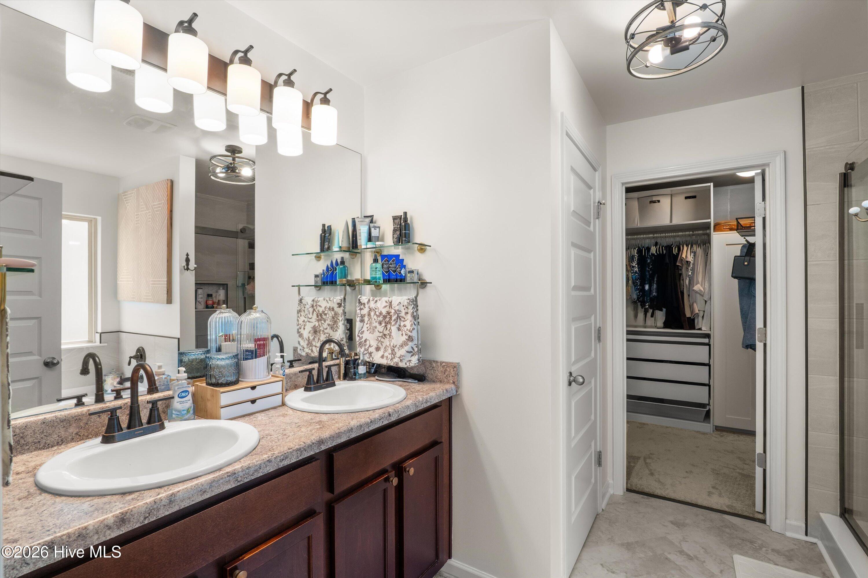 Master bath with double vanity, soaking tub and tiled shower