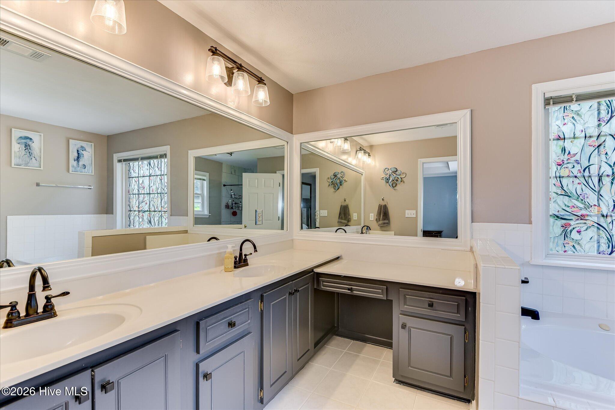 Large En suite Bath with New Upgraded Shower and fixtures. Large Jetted tub, Make up counter and Double Sinks.