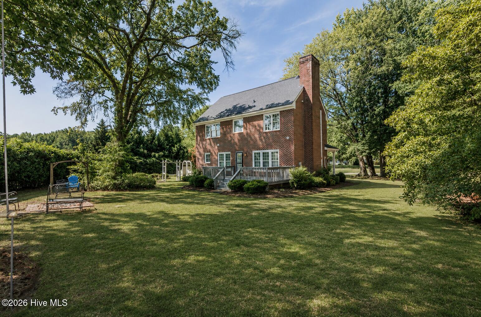 Enjoy the spacious outdoor living area with lush landscape and crepe myrtle surround
