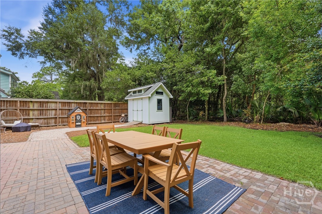 Well maintained and manicured backyard with new storage building, nice Brock paver patio for entertaining, cookouts