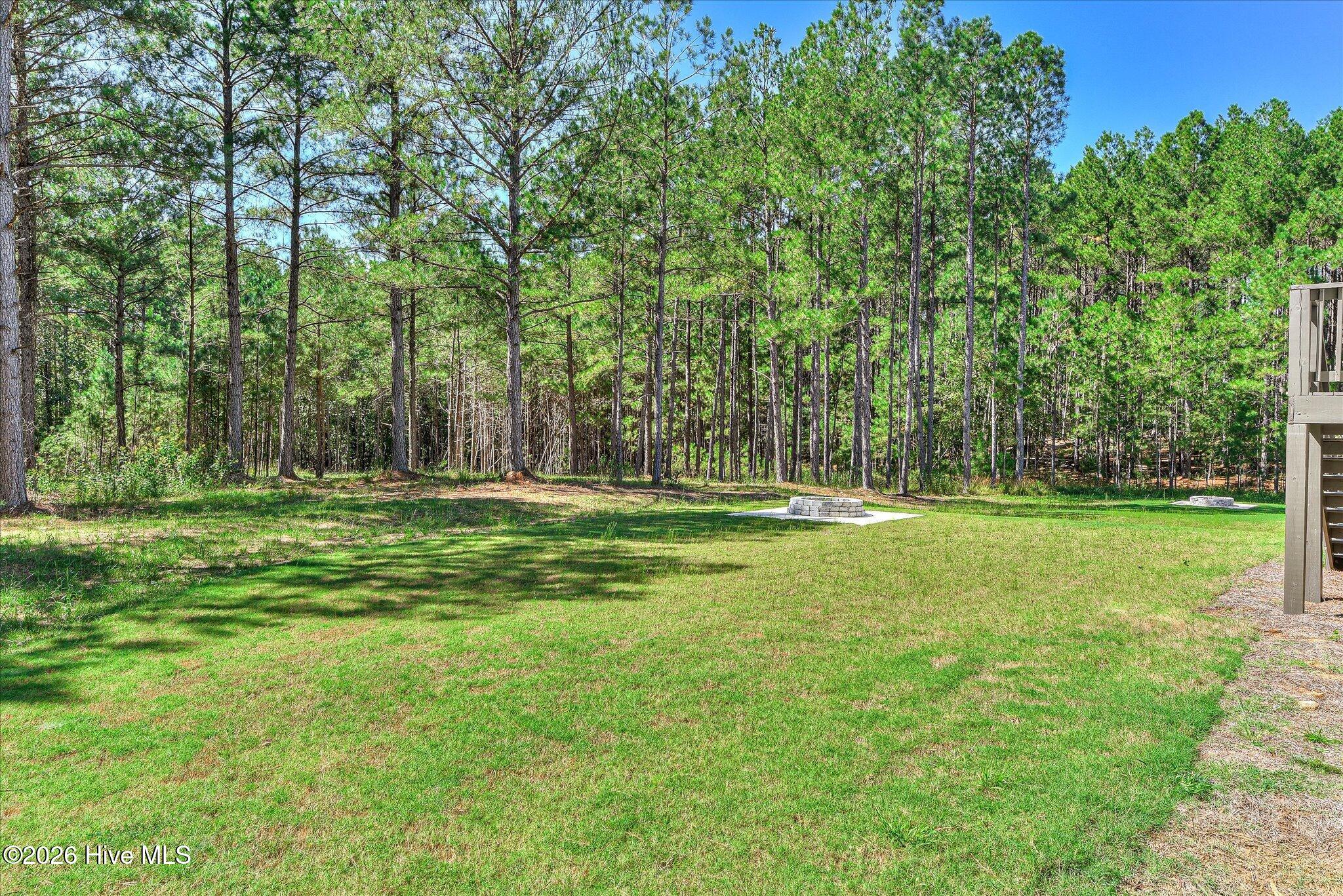 Large backyard with fire pit and trail to the lake, lot is dockable when water levels return to normal.