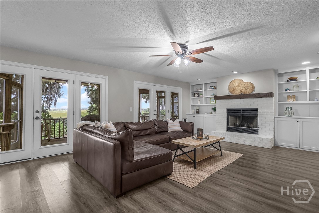 living room with a cozy fireplace and water view
