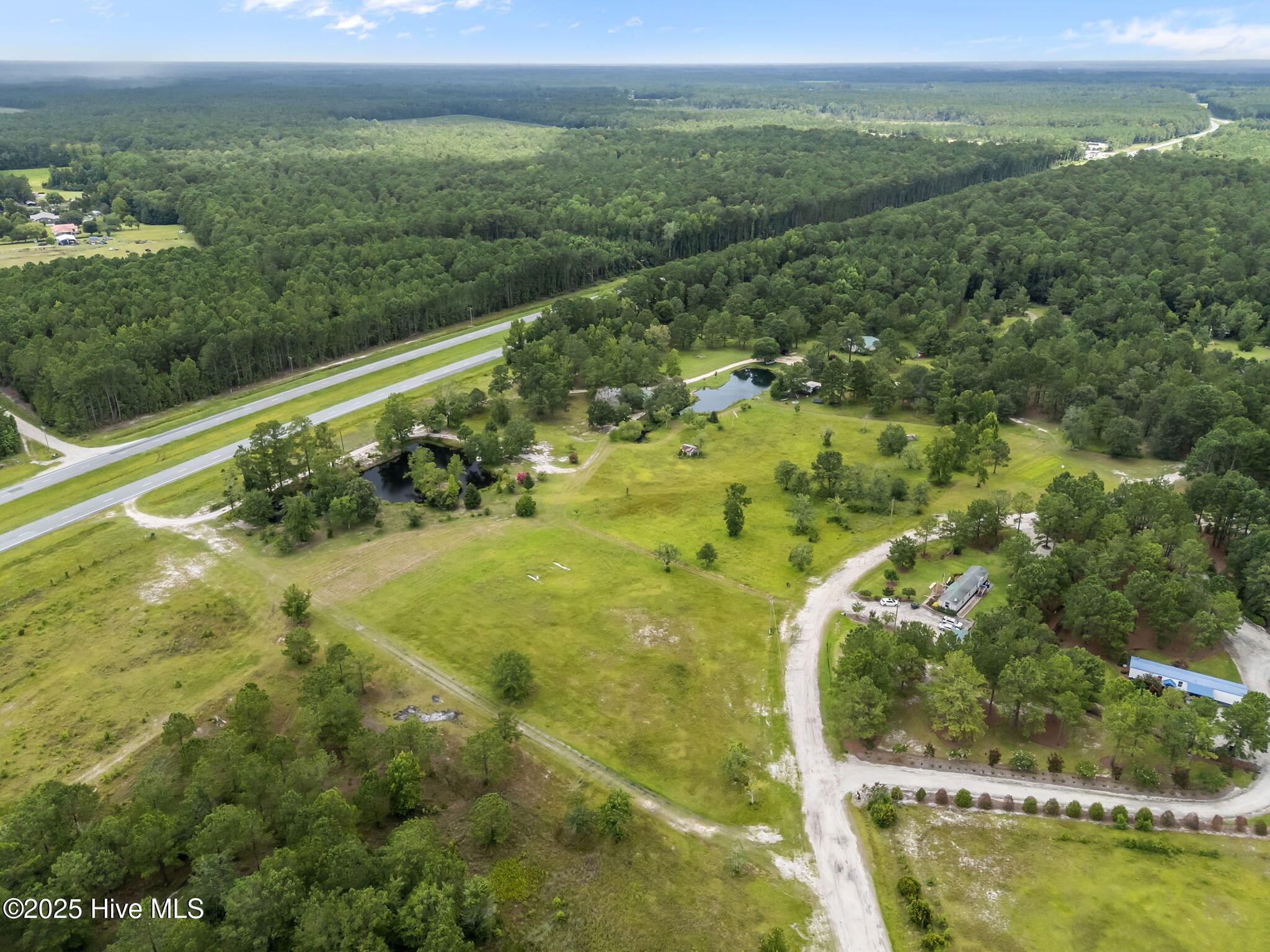 Outstanding Residential Development Opportunity - Approx. 23.04 Acres Off Highway 421A rare opportunity for residential developers or commercial investors seeking a peaceful, rural setting with growth potential. Located just off Highway 421, this offering includes two contiguous parcels totaling approximately 23.04 acres of cleared, buildable land. The smaller parcel features an existing owner-occupied residence, multiple outbuildings, and two scenic ponds, adding character and flexibility to future development plans.This property is ideally suited for a low-density residential community, family compound, or private estate lots. The surrounding area remains largely rural, but signs of development and infrastructure expansion suggest long-term upside. With direct access to a major highway and room for thoughtful planning, this land offers the best of both worlds—tranquility today and potential tomorrow.