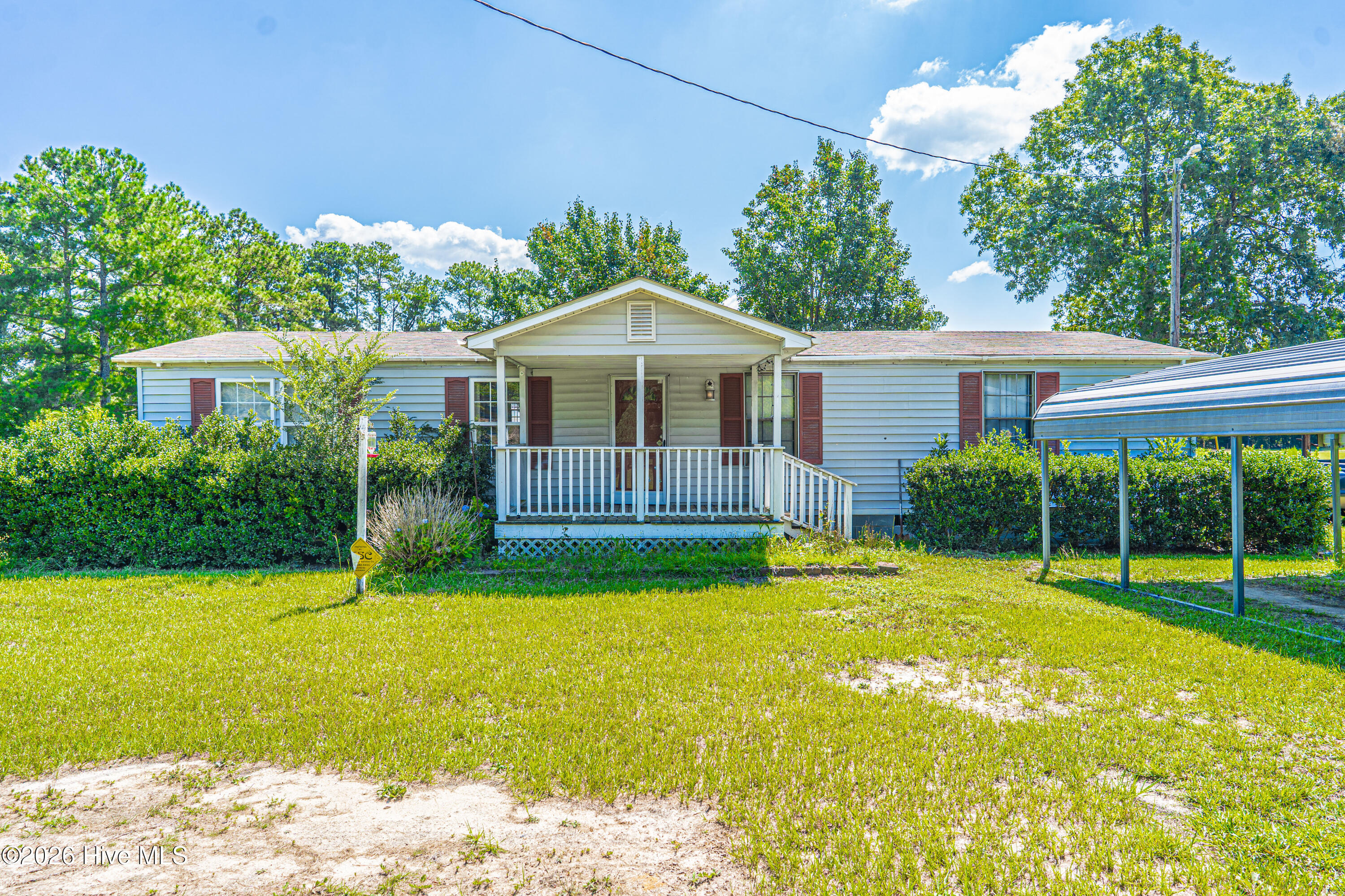 Welcome home to the well-maintained double-wide manufactured home offering over 2 acres of land, comfort, space, and country living.  Relax on the inviting covered front porch, perfect for enjoying your morning coffee or unwinding in the evenings.Inside, you'll find a spacious living room that flows into the kitchen, creating a welcoming layout for everyday living and entertaining. The home features three spacious bedrooms, two full bathrooms, including a primary bathroom with a convenient walk-in shower and a second bathroom with a tub/shower combination.Outside, the property includes a detached carport for covered parking, a storage shed for your tools and outdoor equipment, and the convenience of a private well and septic system.Whether you're looking for your first home, downsizing, or seeking a peaceful place to call home, this property offers comfort, functionality, and great value. Schedule your private showing today!