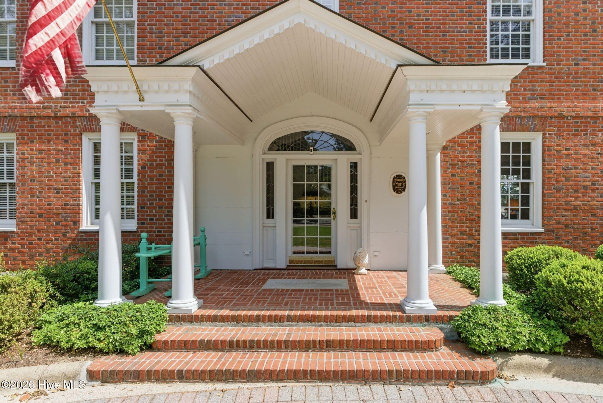 The front approach is distinguished by the home’s Neo-Georgian symmetry and preserved architectural detailing.