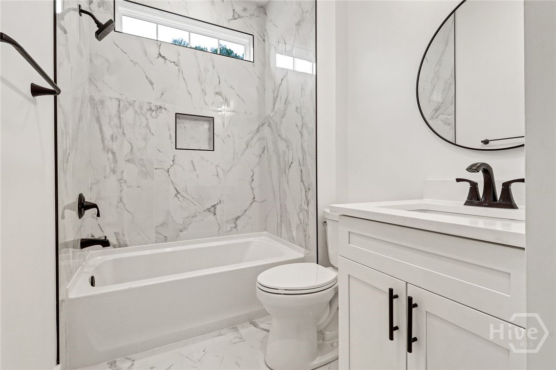 Guest bathroom with tiled tub shower combo
