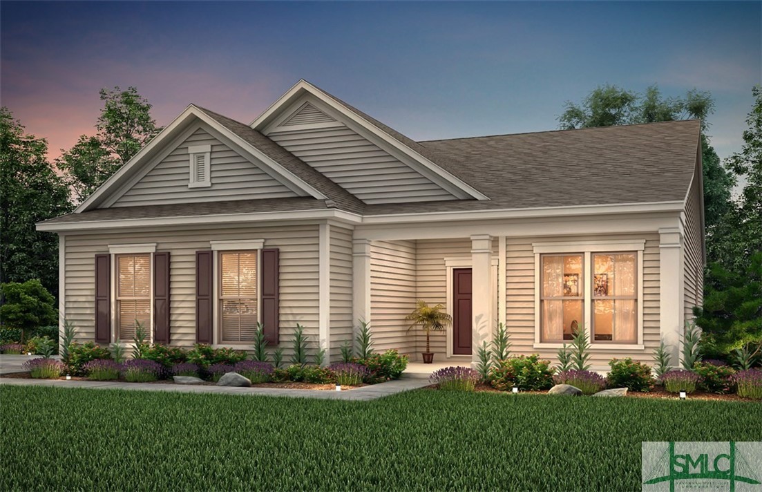 Single-story beige house with a recessed entry, landscaped flower beds, and a broad green lawn.