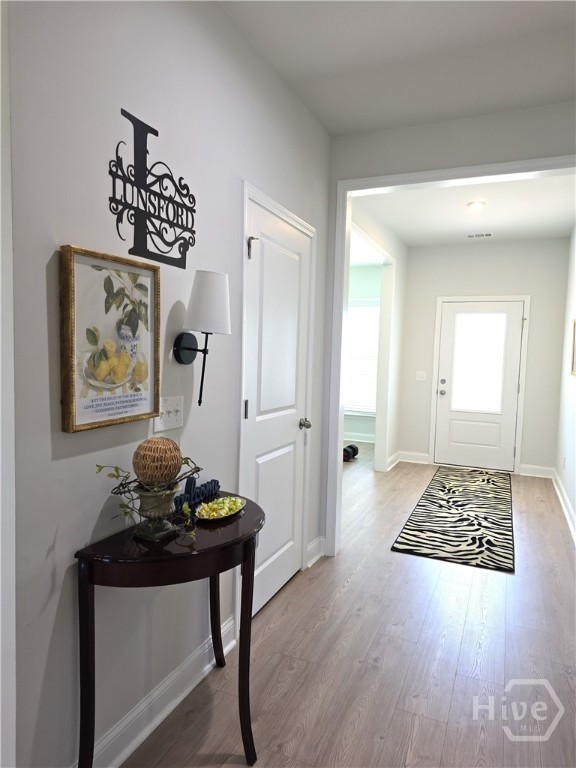 Log foyer allows for Dining Area and garage entry, and Desk Area.