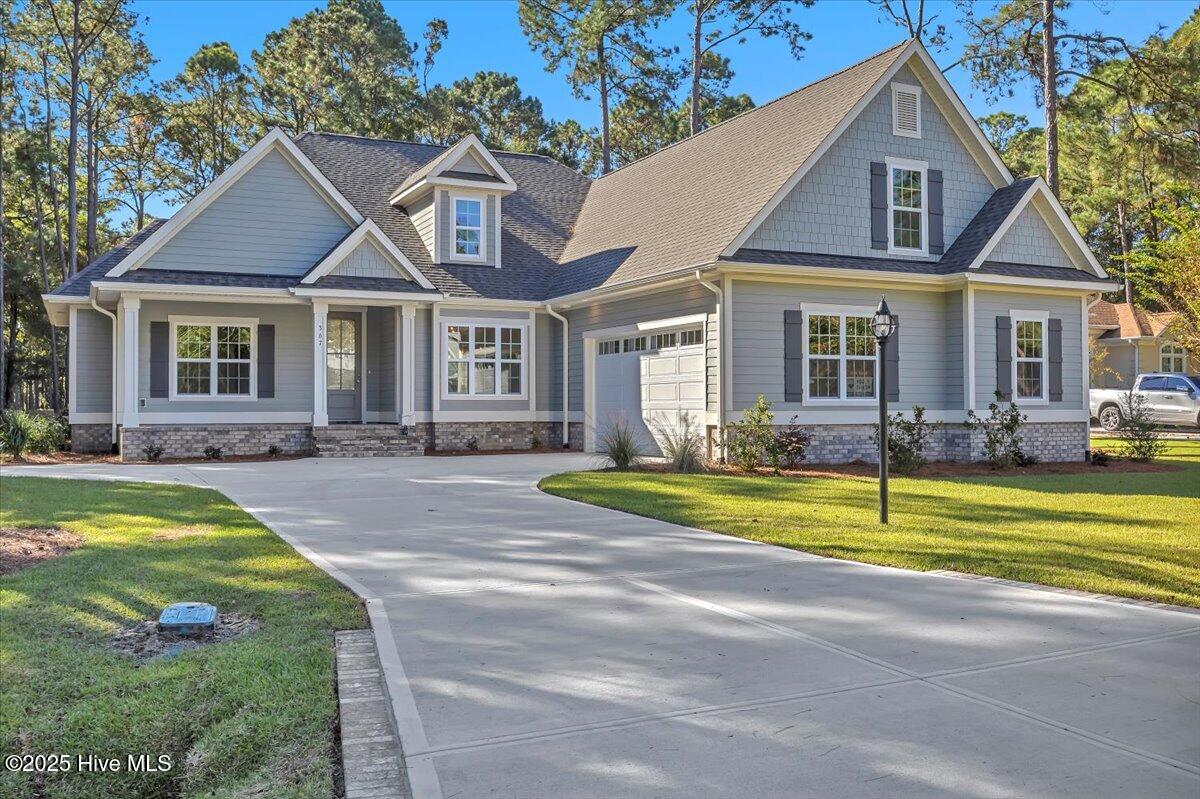 PRICE ADJUSTMENT & NOW READY TO CALL HOME!  The Krystal's Retreat by Howard Builders offers an open, spacious split floor plan designed for comfort and elegance. The large great room features coffered ceilings, a stunning gas fireplace, and custom built-ins—creating a warm and inviting centerpiece for the home.The gourmet kitchen includes a 5-burner gas cooktop, built-in microwave and wall oven, a generous center island topped with quartz, and plenty of space for cooking and entertaining. An open formal dining room and a bright breakfast area provide flexible options for meals and gatherings.The luxurious master suite features a tray ceiling, an elegant spa-style tiled shower, and a spacious walk-in closet with convenient direct access to the laundry room. Enjoy beautiful golf course views from the sunroom or the screened lanai, perfect for relaxing outdoors all year long.A large bonus room with a full bath makes the ideal guest suite or private retreat. Howard Builders homes include premium standard features such as a hot water circulation system—providing near-instant hot water throughout the home—and a buried 250-gallon propane tank that supplies the gas cooktop and fireplace.Located in Lockwood Folly, an amenity-rich golf course community with easy access to Brunswick County's stunning beaches, historic Southport, Myrtle Beach SC, and Wilmington NC