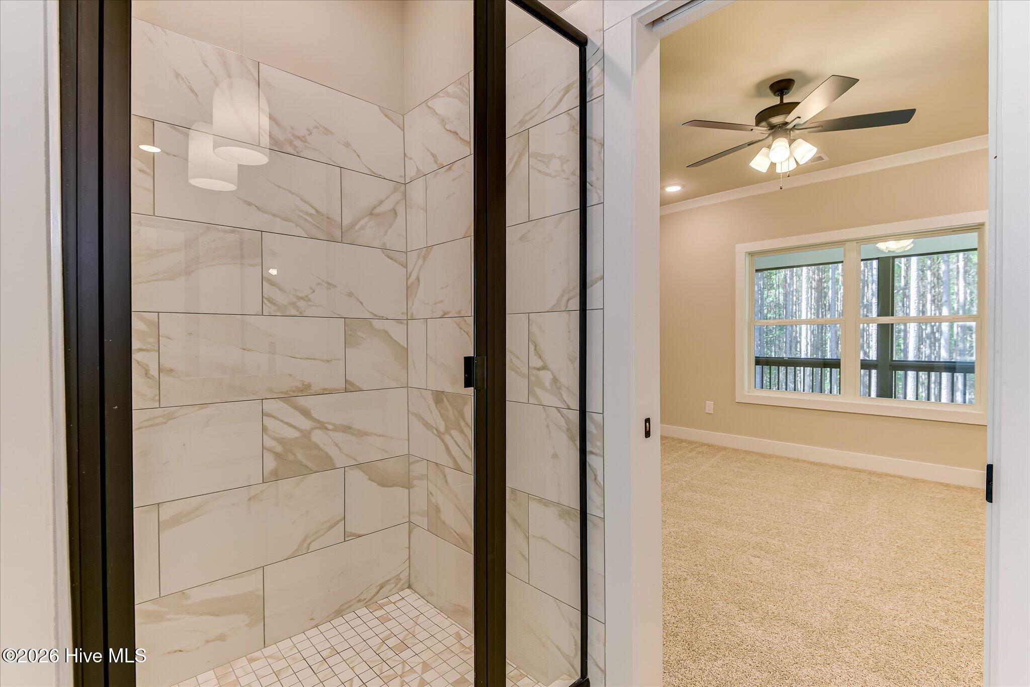 Primary Ensuite with double-sink vanity, tile shower, large walk-in closet