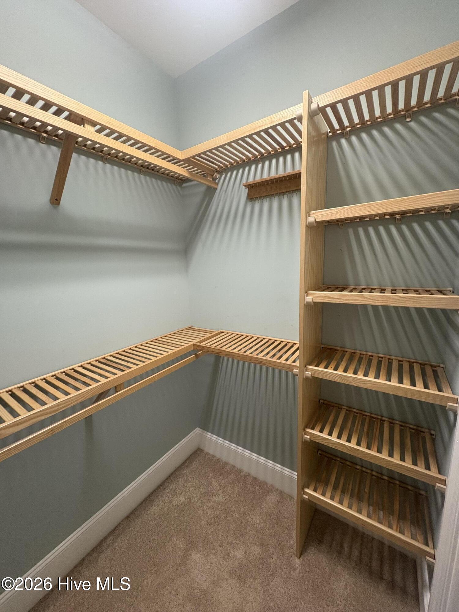 walk in closet #1 with built in wooden shelves