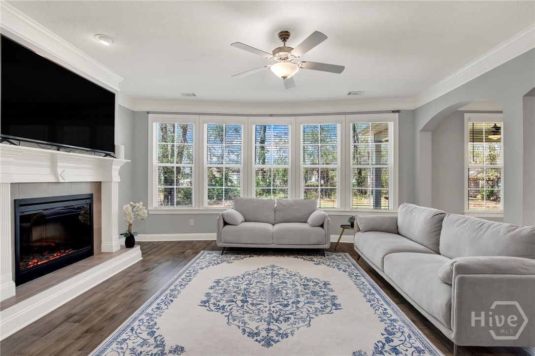 Family Room with Fireplace and Curved Wall of Windows