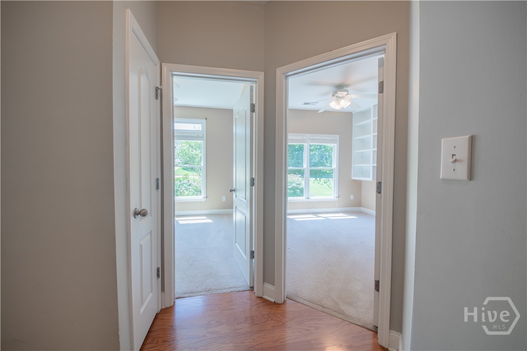 Hallway adjoining Primary Suite to bedrooms