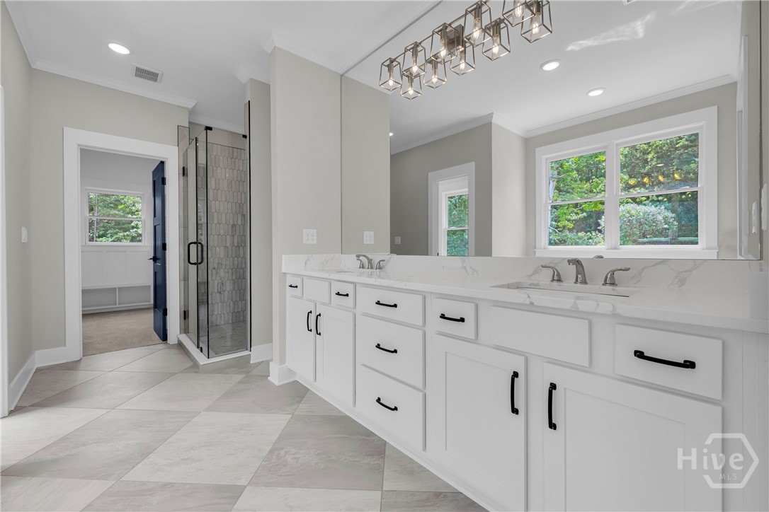 Double vanity with white cabinetry and quartz countertops