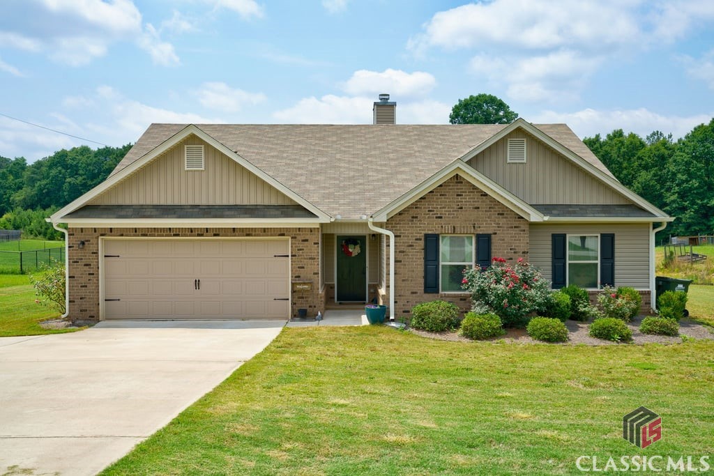 Come home to a country living feel while being moments to grocery stores, restaurants, and the Classic City! This spacious ranch is bright and cheery with an open concept floor plan that features a greatroom, kitchen, dining room w/ wainscoting, and sunroom/home office. Built-ins were added adjacent to the masonry fireplace. The kitchen features stainless steel appliances, undermount sink, and granite countertops - plus a walk-in pantry. Several arched casement openings lead to the dining area and home office - spaces which could be used as a sunroom or additional seating areas. Owner's Suite is spacious and has an ensuite bathroom with separate shower and tub. Three additional bedrooms share the hall bathroom, and there is a half-bath for guests as well. French doors lead to a concrete patio that overlooks the 1.27 acre lot - which means a HUGE backyard to enjoy year round. Work from home? This property has access to Spectrum High Speed Internet as well as AT&T Fiber. With zero steps to entry, one could easily convert this home to be fully handicap accessible. Make your appointment to see this home before it's gone!