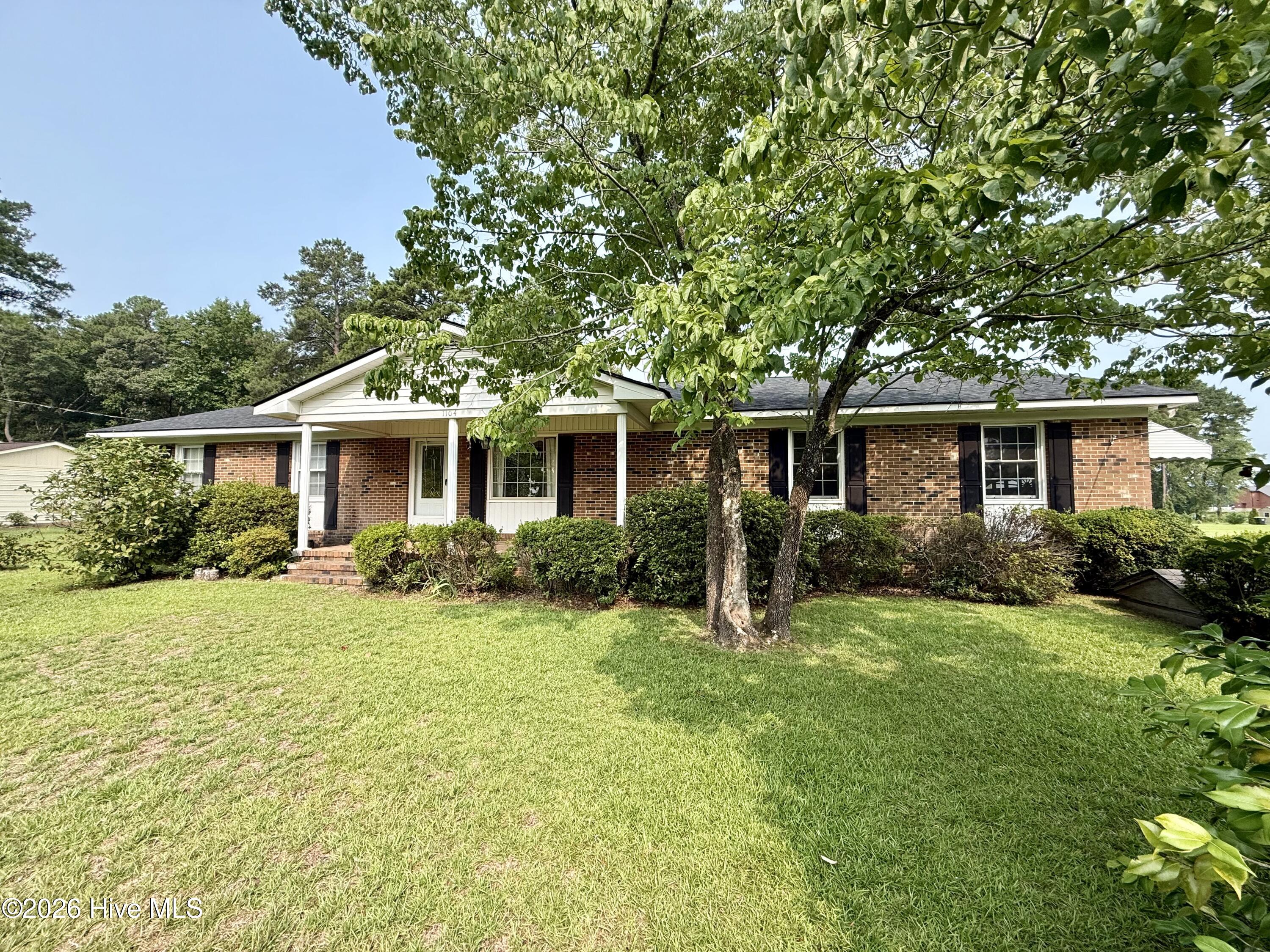 Just listed outside the Town of Williamston! Come see this charming 3-bedroom, 2-bath brick ranch situated on a spacious corner property near the intersection of Highways 64 and 17. An additional lot is also included, providing even more outdoor space and possibilities. The home also features a new roof and new windows, offering valuable updates for the next owner.Inside, the home offers a formal dining room and a well-equipped kitchen featuring tile flooring, abundant cabinet space, and all necessary appliances. The cozy den includes a wood-burning fireplace, perfect for relaxing on chilly evenings, while the formal living room provides additional space that could also be used as a home office, playroom, or flex area.Each bedroom features unique wallpaper that adds warmth, character, and personality throughout the home. The spacious hallway bathroom offers tile finishes and a full tub-and-shower combination. The primary bedroom includes a private en-suite bathroom with a tiled step-in shower and single vanity.The large laundry room includes the washer and dryer, along with a walk-in pantry or storage closet. An attached garage features a convenient entry ramp that may be removed if desired. Outside, you will also find a metal carport shelter and a detached garage that is ideal for storage, hobbies, or workshop space.With its generous corner setting, additional lot, convenient location, new roof, and new windows, this home offers plenty of space, character, and potential. Schedule your private showing today!
