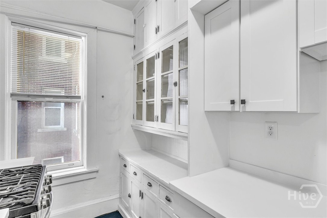 Original built-in cupboard adds charm to the kitchen as well as storage