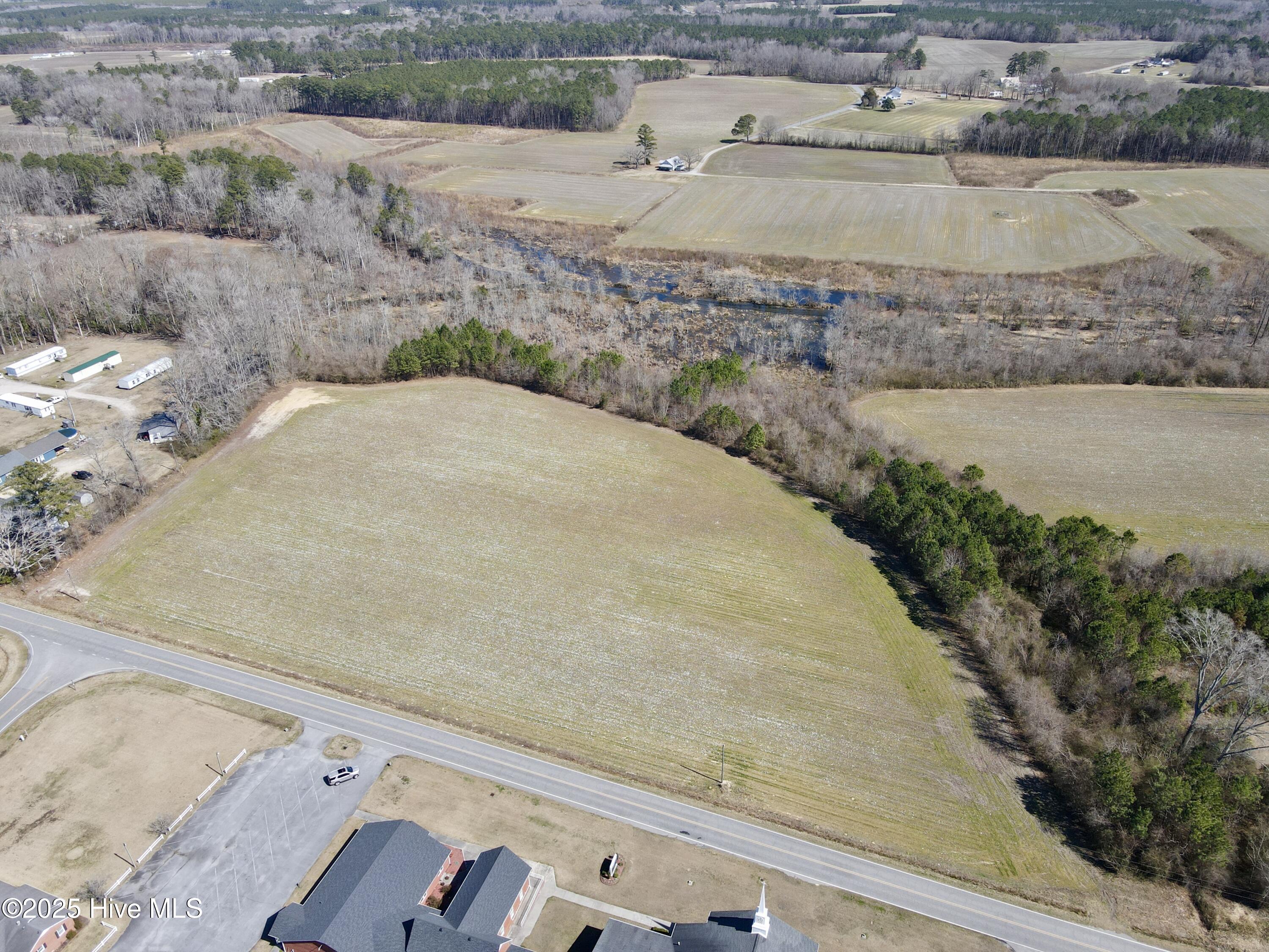 Just listed! Don't miss this rare opportunity to own a cleared, residential level lot spanning approximately 2.09 acres in the desirable Bear Grass community. This property offers endless potential, but act quickly! While there are light restrictions to consider, the lot has been assessed by the County for a septic permit and is approved for a 4 bedroom conventional system. Conveniently located on a busy rural road, the property sits directly across from an active church, adding a sense of community to its appeal. For more details or to secure this unique opportunity, call today!