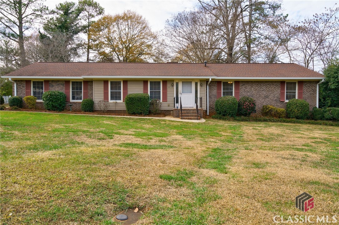 Price Reduced to $335,000 in Crestwood-Green Acres just a stone's throw to The University of Georgia's Veterinary Teaching Hospital! Check out this sprawling and updated four sides brick ranch with a brand new, never used kitchen! Upon entry, notice the new Luxury Vinyl Plank flooring that runs throughout all living areas of the home. Sizable living room leads to formal dining room that could also be used as a home office or additional seating area. Through a cased opening you'll find the breakfast area/ secondary dining area with masonry, wood burning fireplace. After a complete kitchen overhaul, a wall was removed to create better flow between the breakfast area and kitchen. Updates include recessed lighting, custom cabinetry with corner lazy Susan, open shelving, tons of drawers, quartz countertops, brand new stainless steel appliance package, and new flooring. Just off the kitchen is a gorgeous sunroom with casement windows that will allow ample airflow in the cooler months. Down the hallway is the shared bathroom with jetted tub for two additional bedrooms. Owner's Suite features an ensuite bath with tiled shower stall. Newer 30 Year Architectural roof and HVAC system, plus new water heater! Huge, fenced backyard is perfect for gardening or gatherings and features a metal storage building. Laundry room is located off the kitchen as is the two car attached garage. Schedule your private tour today!