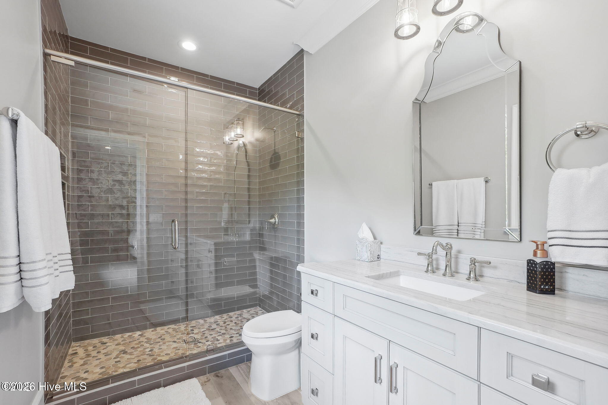 Walk-in shower with heavy plate glass door with rain head and handheld temperature control multi val