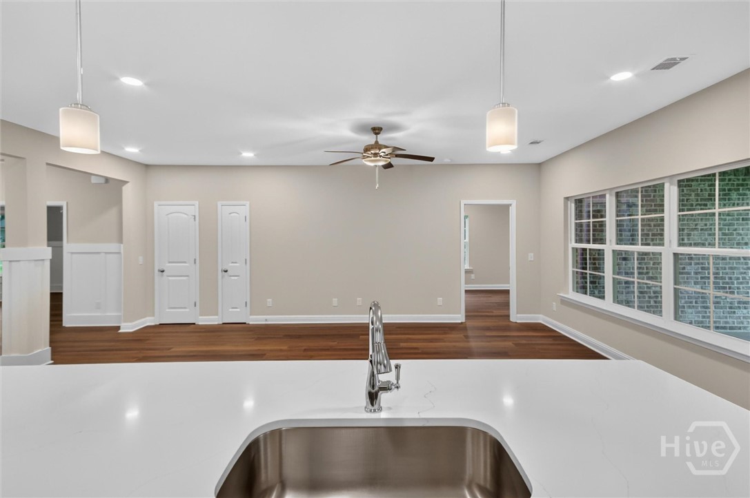 Kitchen with quartz counter tops open to living room