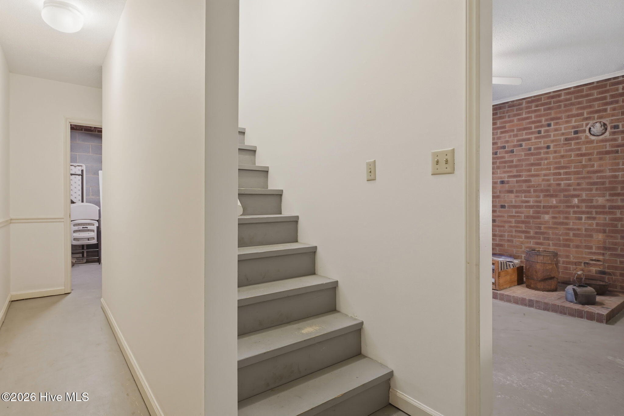 Stairwell to lower office area from kitchen. Hallway to the utility room and storage area under the stairwell.