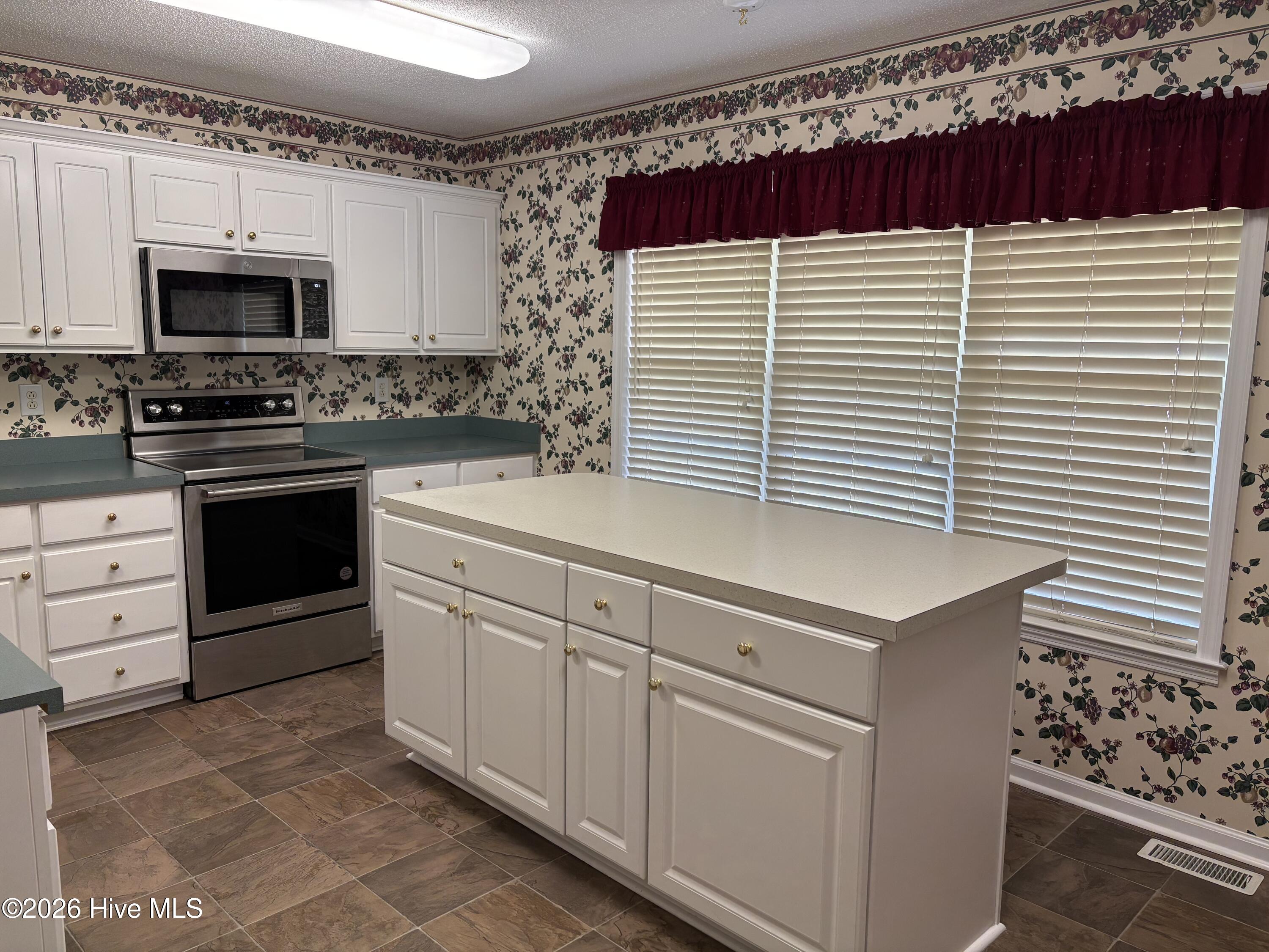 Kitchen island has counter for bar stools