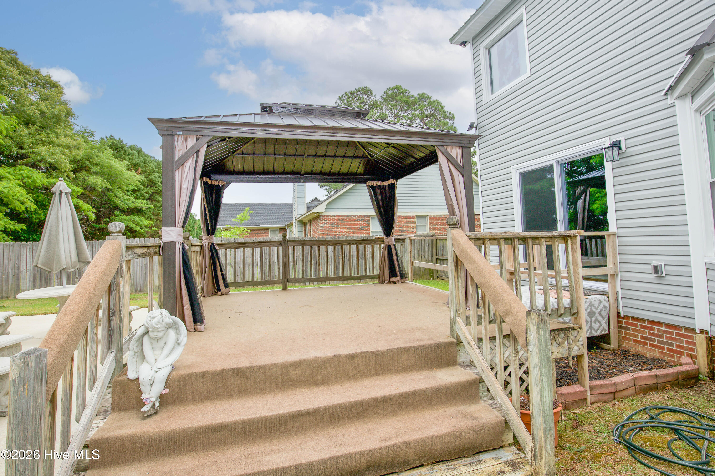Elevated deck and gazebo area offering direct access to the backyard entertaining spaces and pool. This covered outdoor living area creates a functional extension of the home with room for outdoor seating, dining, relaxing, or hosting guests throughout the year. Outdoor entertaining features like this continue to stand out to buyers searching for move-in ready homes near Fort Bragg and Fayetteville amenities.