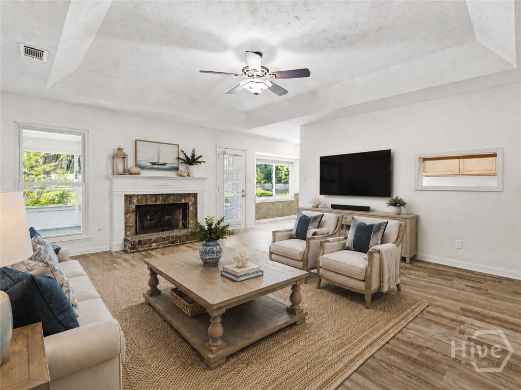 The living room has been virtually staged to show you how it would look with furniture and decor.