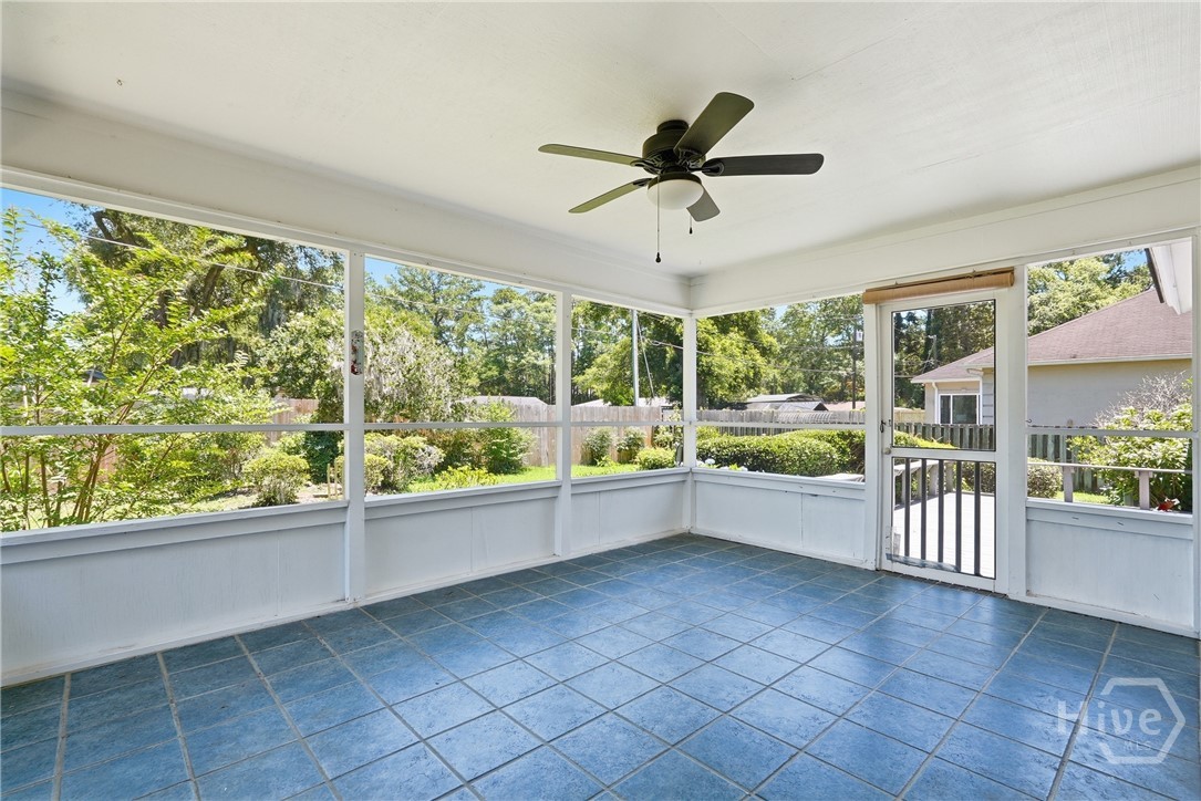 The screened porch has a finished tile floor and ceiling fan
