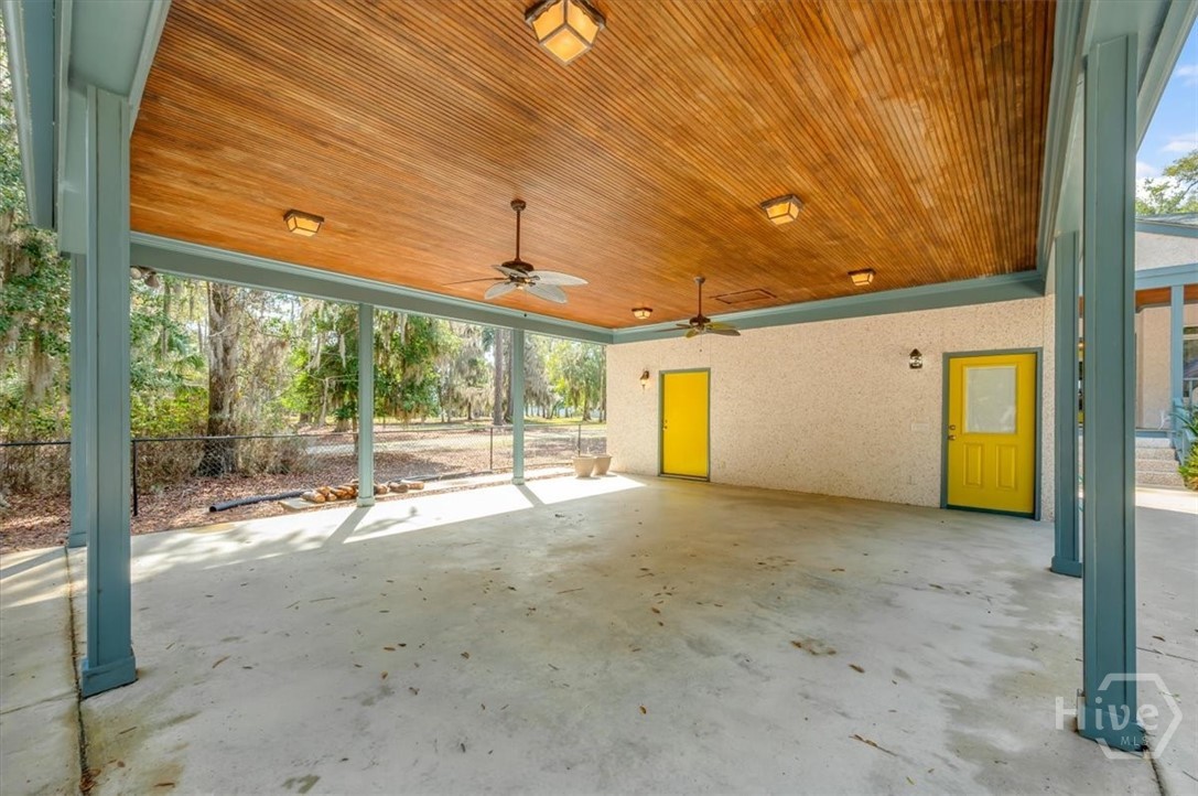 Double Carport with stained tongue and groove ceiling to match porches.