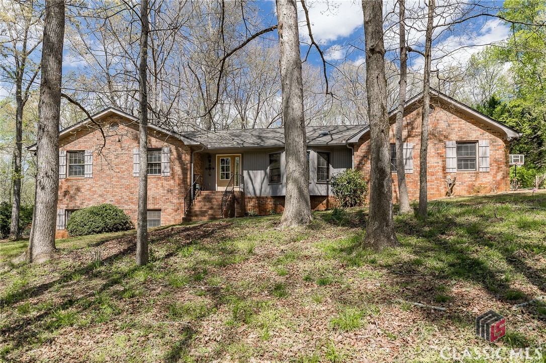 Here it is, your brick ranch over a basement in Oconee County’s Hickory Hill neighborhood. Nestled on a deep lot, this spacious property has plenty of room inside and out! Nearly 4000 square feet of living space, this home has endless possibilities for customizing your dream home layout. Updated with a new roof, new water heater, and newly refinished wood floors throughout the main floor. The main floor features multiple cozy living areas connected by a warm and inviting kitchen which seamlessly transitions into a formal dining room, perfect for hosting gatherings and entertaining guests.  Around the corner from the kitchen is a laundry/mud room, a convenient half-bathroom, and built-in storage.Retreat to the private owner's suite, tucked away down the hallway, offering ample space with dual closets and an ensuite bathroom. There are three additional bedrooms off the main hallway and a newly renovated full bath. Step outside onto the 15X18 screened porch, extending your living space and providing a tranquil relaxing spot overlooking the large fenced in backyard.Venture downstairs to the large basement with several additional rooms. Use this space for extra living areas, game room/music room, or guest quarters. Equipped with a full bathroom, and a workshop, allowing for ample flexibility and customization. The storage room comes with built-in shelving, a workbench, and exterior access, ensuring functionality and convenience.Discover the endless potential of this remarkable property, offering both space and versatility to accommodate your unique lifestyle needs.