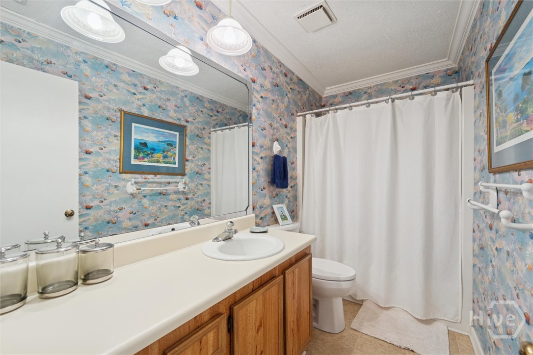 A full second bath upstairs serves the guest room.