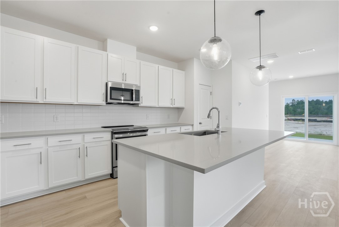 Image shown for design reference. Actual home will feature gray cabinetry with Carrera Miska Countertops. See sales consultant for details.