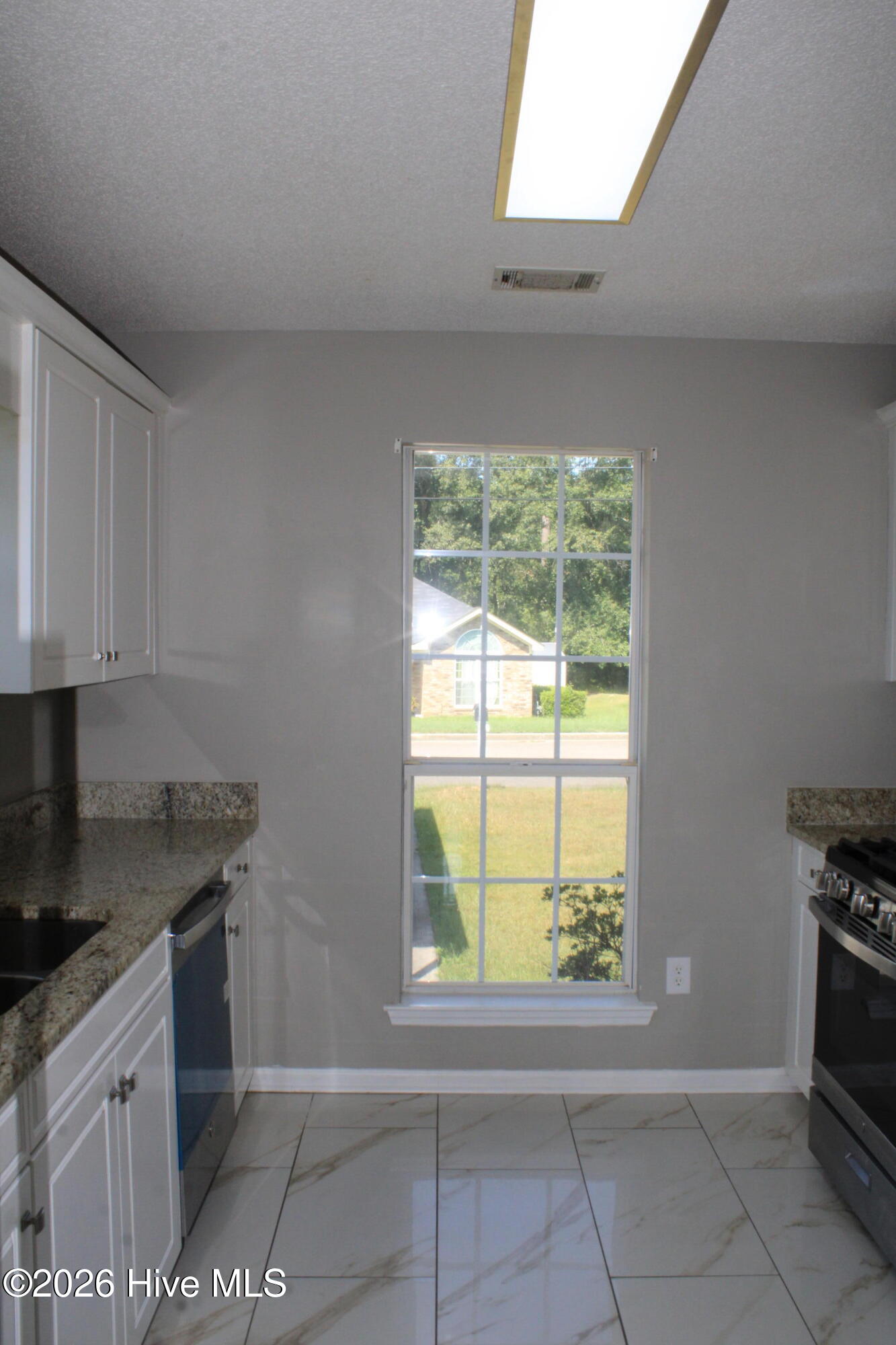 Porcelain tile floors, granite countertops and pantry.