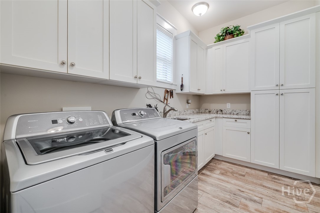 Laundry room with more cabinetry and sink