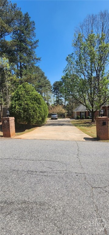 Welcome to this beautifully updated single-story brick home, perfectly situated on a full acre corner lot with gorgeous flowering trees and a fully fenced backyard! Step inside and fall in love with the soaring high ceilings, tasteful modern paint colors, and brand new flooring throughout. The heart of the home is the stunning, fully renovated kitchen featuring brand new cabinets, sleek countertops, and updated appliances-ideal for both everyday cooking and entertaining. The spacious layout includes two inviting decks-perfect for relaxing mornings or hosting guests. This thoughtfully maintained home also features a 2-car garage,a beautiful fireplace dividing the living room and dining room, and seamless flow that makes single-level living a breeze. Outside, the fenced backyard offers plenty of room to garden, play, or simply enjoy your peaceful surroundings. Don't miss the chance to own this turnkey gem with curb appeal, modern upgrades, and room to spread out-all in a serene, tree-lined setting! Check out video tour on Youtube by typing in the address!