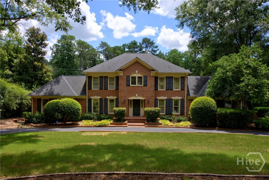 Welcome to 105 Moss Side Drive, a stately all brick residence offering timeless Southern charm in one of West Athens’ most sought after neighborhoods. Perfectly positioned on a beautifully manicured lot just minutes from Athens Country Club and Piedmont Hospital, this home delivers elegance, comfort, and space.

A sweeping circular drive leads to the gracious entry, where a soaring two story foyer sets the tone for the light filled interiors. The main level features a cozy den, formal dining room, and an inviting fireside family room that flows seamlessly into the open chef’s kitchen. Appointed with marble countertops, a farmhouse sink, custom cabinetry, gas cooking, and high end stainless steel appliances, the kitchen is designed for both style and function.

The main level owner’s suite offers a private retreat with double French doors, custom built-ins, two closets, and a bath with dual vanities. Upstairs, a second owner’s suite provides exceptional flexibility, along with two additional spacious bedrooms and a shared hall bath.

The finished daylight basement is a true extension of the living space, offering a large recreation area with fireplace, theatre room, bedroom, full bath, kitchenette, and abundant storage.

Outdoors, relax on the screened porch or entertain on the open deck overlooking the fenced backyard surrounded by mature trees and natural privacy.

If you’ve been searching for a home with multiple owner’s suites, a finished basement, generous outdoor living space, and a premier location, 105 Moss Side Drive is the perfect match. Schedule your private tour today.