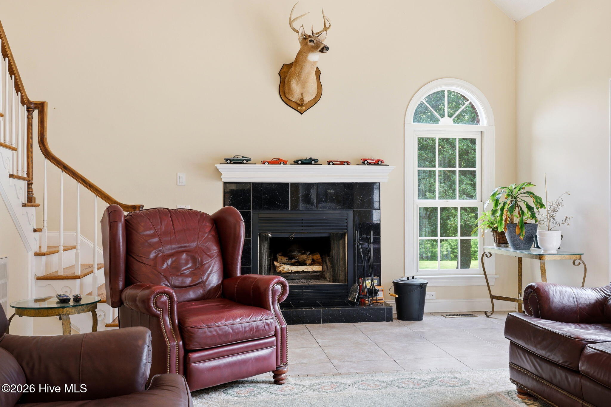 fireplace and arched window - back staircase ( there is a front access at foyer as well