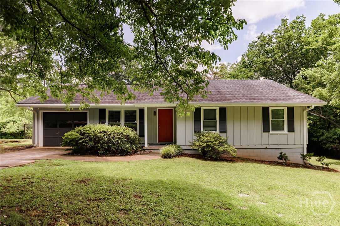 Super convenient to UGA and Downtown Athens, yet tucked away in a calm, quiet setting! Enjoy an exceptional in-town location just 2 blocks from the Greenway Park and trail system, 4 blocks from the Classic Center, and only 7 blocks from UGA's North Campus. With a single-car garage, plenty of street parking, and access to bus lines, this home offers outstanding convenience for work, school, and recreation.Impeccably maintained and move-in ready, this precious single-level ranch offers the perfect combination of comfort, convenience, and style. Nestled on a lush, beautifully maintained lot, the home boasts inviting curb appeal and a fully fenced backyard—ideal for entertaining, gardening, pets, or simply enjoying your own private outdoor retreat.Inside, you'll find fresh interior paint, durable laminate wood flooring, and thoughtful storage throughout. The spacious floor plan features four generously sized bedrooms, each equipped with ceiling fans and sizable closets. The primary suite offers a private en suite bath complete with tile flooring, a new vanity, upgraded lighting, and a tub/shower combination.The graciously sized kitchen is bright and functional, showcasing crisp white cabinetry, ample black laminate countertops, and a large pantry for exceptional storage. Just off the kitchen, a deep laundry closet provides added convenience with built-in shelving above for organized storage.Three additional bedrooms comfortably accommodate queen-sized beds and share a beautifully renovated hall bath featuring a large vanity, updated lighting, and a tub/shower combo.A deep single-car garage adds even more versatility, offering ample room for parking as well as additional storage space for lawn care equipment, tools, bicycles, and seasonal items.With its excellent condition, practical layout, abundant storage, and highly desirable location near UGA and Downtown Athens, this charming ranch is move-in ready and waiting to welcome its next owner home.