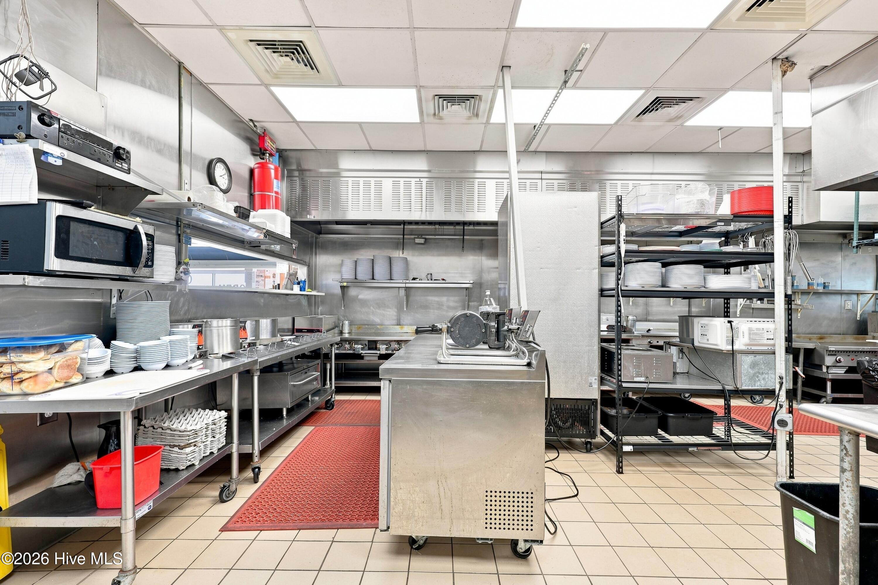 Stainless kitchen equipment is abundant.