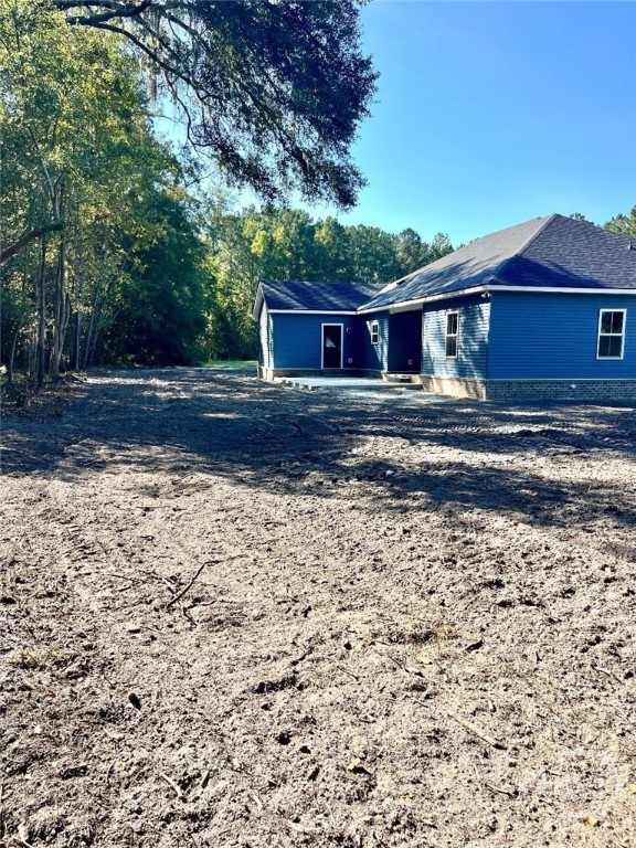 View showing shady back yard, landscape in progres