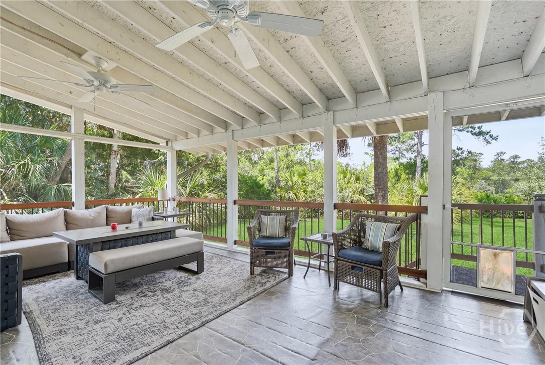 Screened in porch overlooking backyard and marsh. Grass digitally enhanced for marketing.