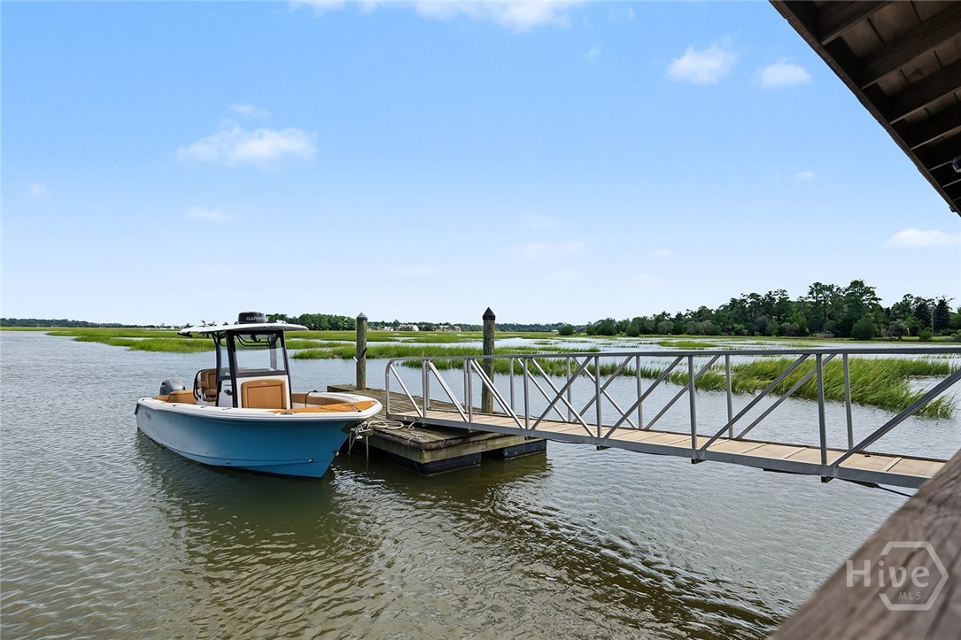 Screened-in dock house with boat lift and floating dock