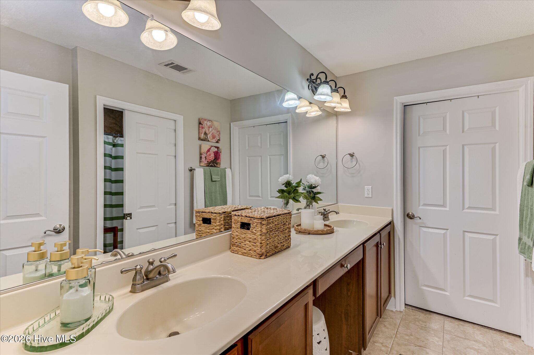 owners bathroom with duel sinks and sperate wet room